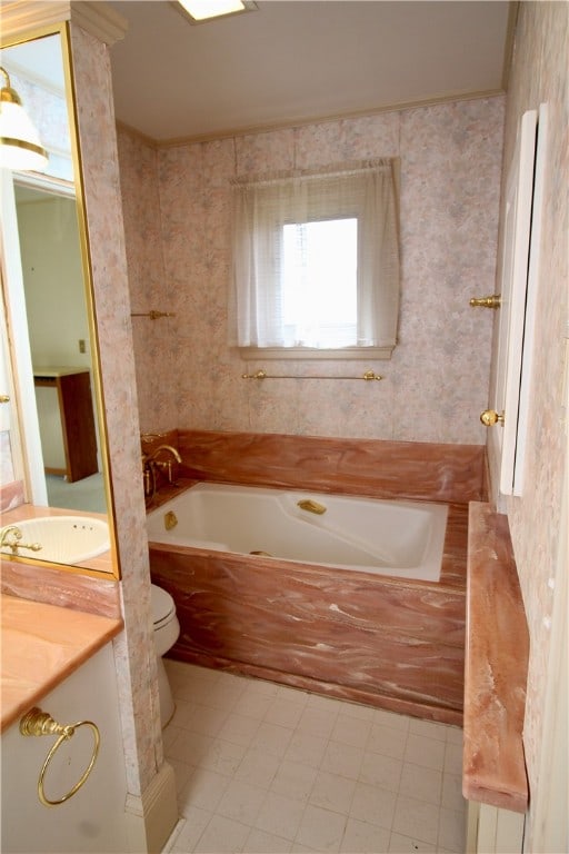 bathroom featuring toilet, vanity, tiled tub, and tile patterned floors