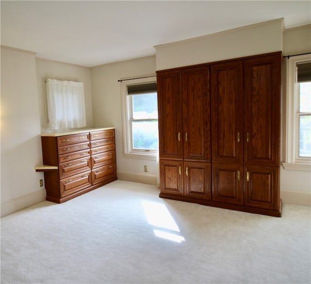 unfurnished bedroom featuring light carpet