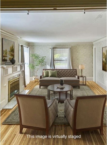 living room featuring light hardwood / wood-style flooring and crown molding