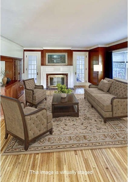 living room with light hardwood / wood-style flooring, a brick fireplace, and a healthy amount of sunlight