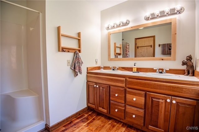 bathroom featuring vanity, hardwood / wood-style floors, and a shower with curtain