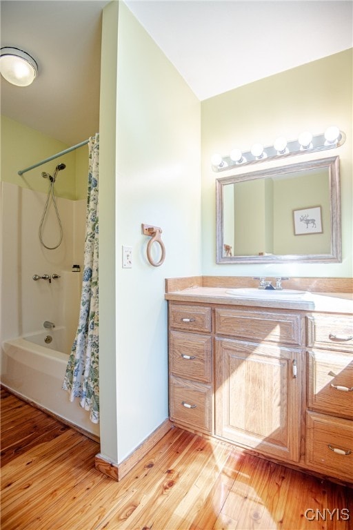 bathroom with vanity, hardwood / wood-style floors, and shower / bath combination with curtain