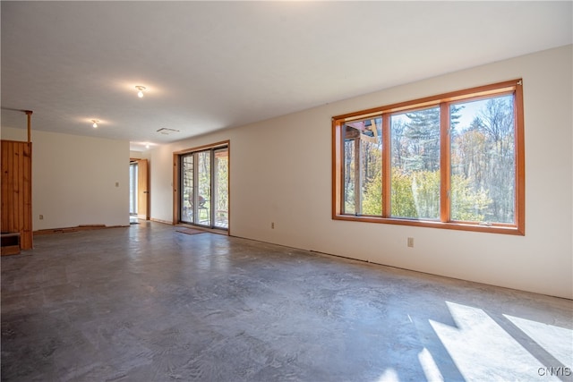 unfurnished room featuring concrete floors