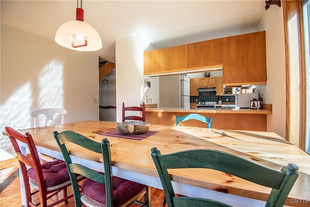 dining space with light hardwood / wood-style flooring