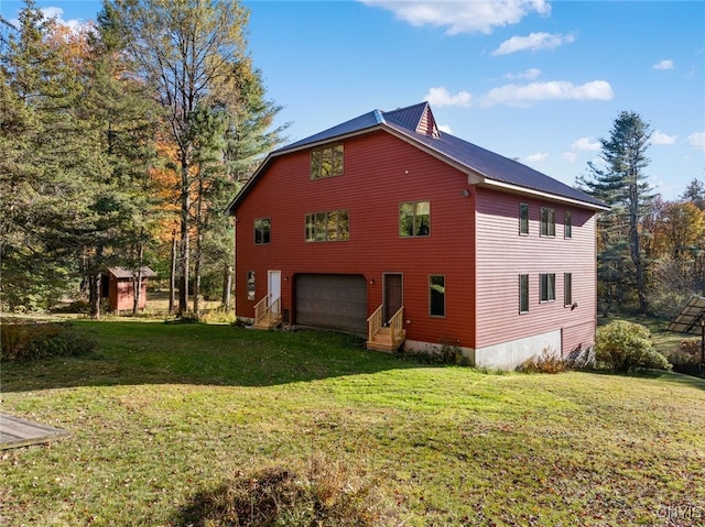 view of side of property with a lawn and a garage