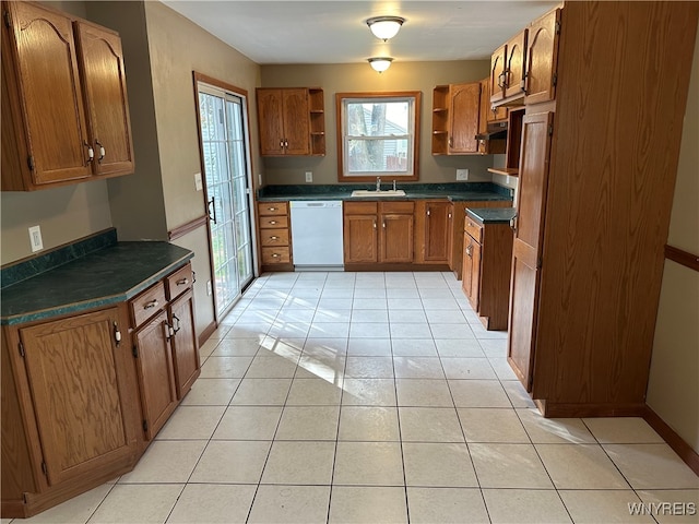 kitchen with sink, dishwasher, and light tile patterned flooring