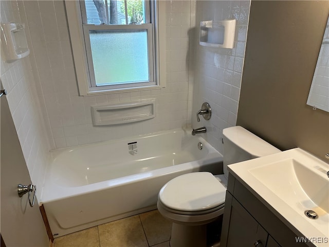 full bathroom featuring vanity, toilet, tiled shower / bath combo, and tile patterned floors