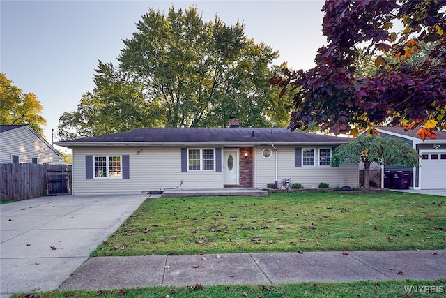 ranch-style home with a front yard and a garage