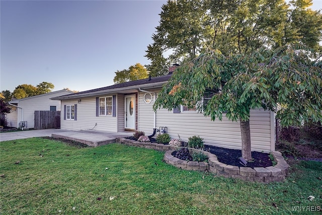 ranch-style home featuring a patio area and a front lawn