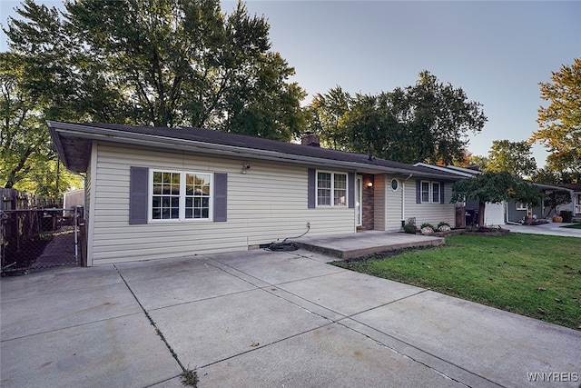 single story home with a patio and a front lawn