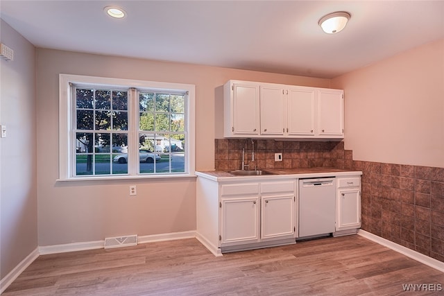 kitchen featuring white cabinetry, light hardwood / wood-style floors, white dishwasher, and sink