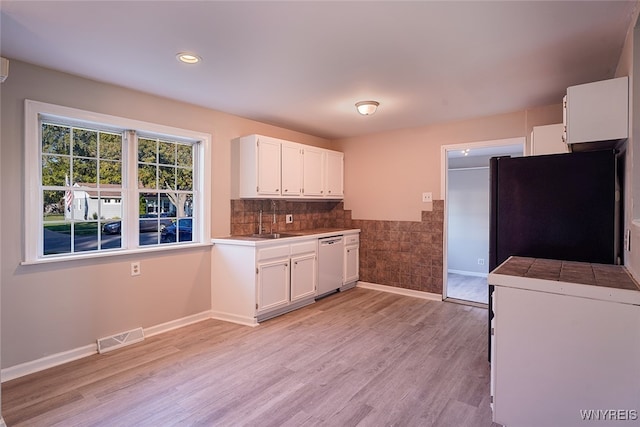 kitchen featuring light hardwood / wood-style flooring, white cabinets, sink, and white appliances