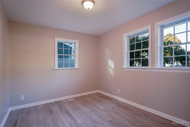 spare room featuring light hardwood / wood-style floors