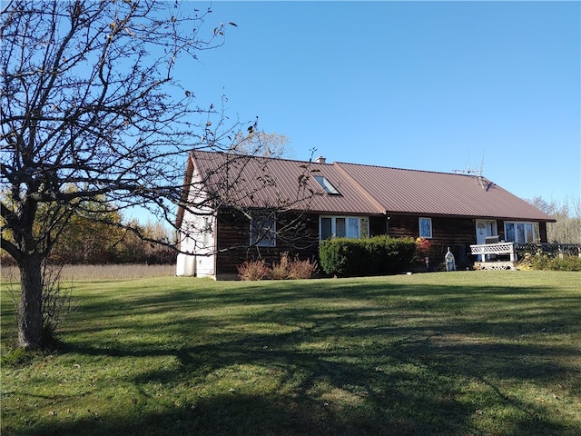 rear view of property with a lawn