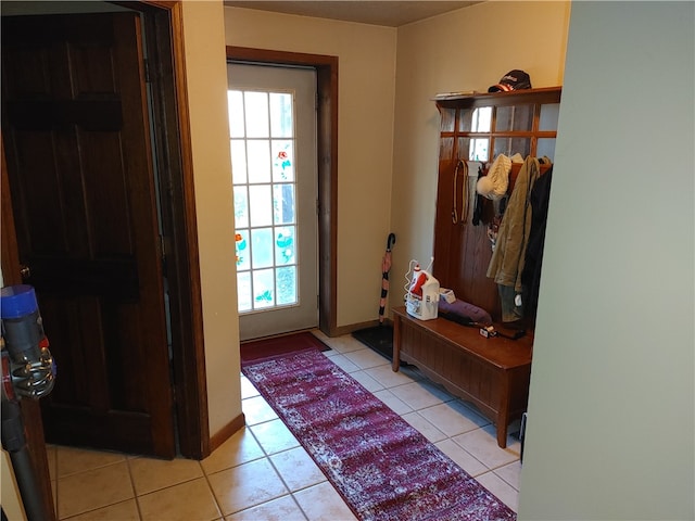 doorway to outside featuring light tile patterned flooring