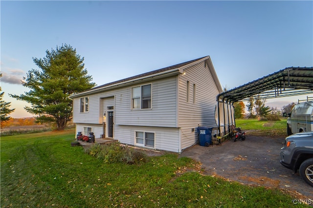 view of front of house featuring a lawn and a carport