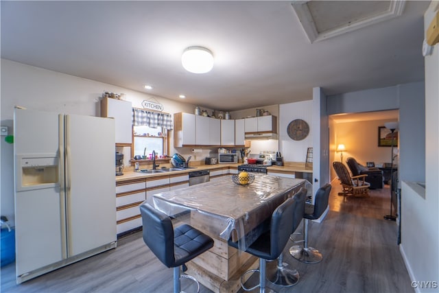 kitchen with sink, appliances with stainless steel finishes, light wood-type flooring, and white cabinets