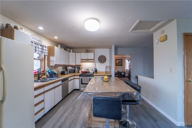 kitchen featuring white cabinetry, light hardwood / wood-style floors, appliances with stainless steel finishes, and sink