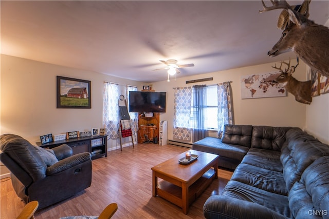 living room featuring hardwood / wood-style flooring, a baseboard radiator, and ceiling fan