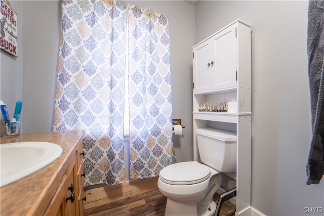 bathroom featuring vanity, toilet, and hardwood / wood-style floors