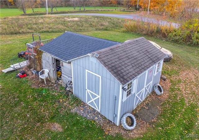 view of outbuilding featuring a yard