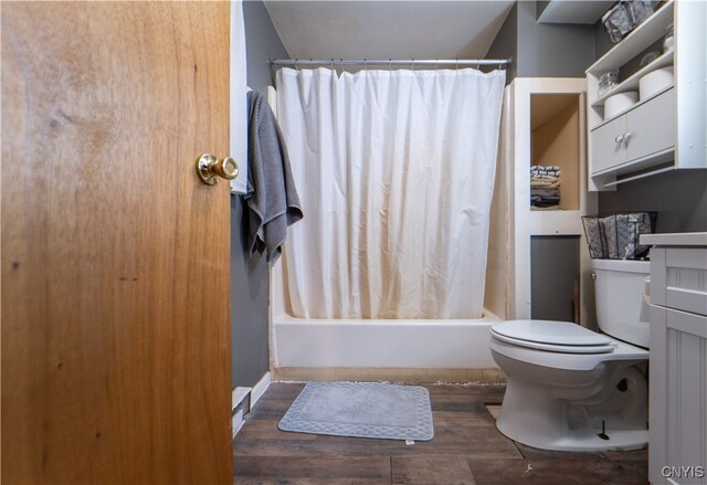 full bathroom with vanity, toilet, wood-type flooring, and shower / tub combo