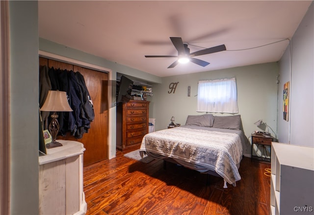 bedroom with a closet, dark hardwood / wood-style floors, and ceiling fan