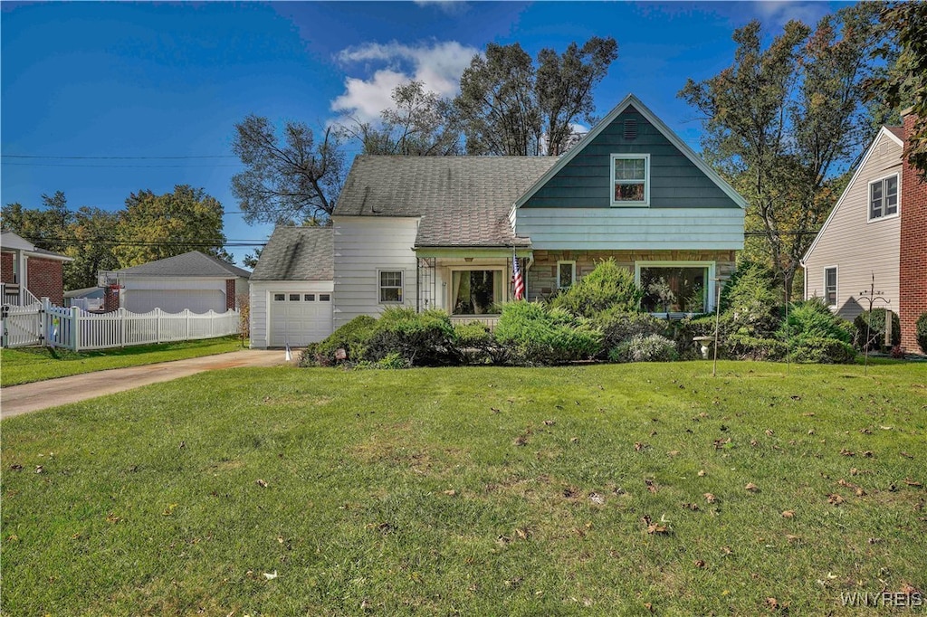 view of front of property with a front yard and a garage