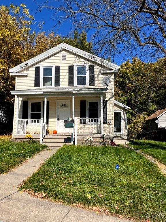 view of front of house featuring covered porch and a front lawn