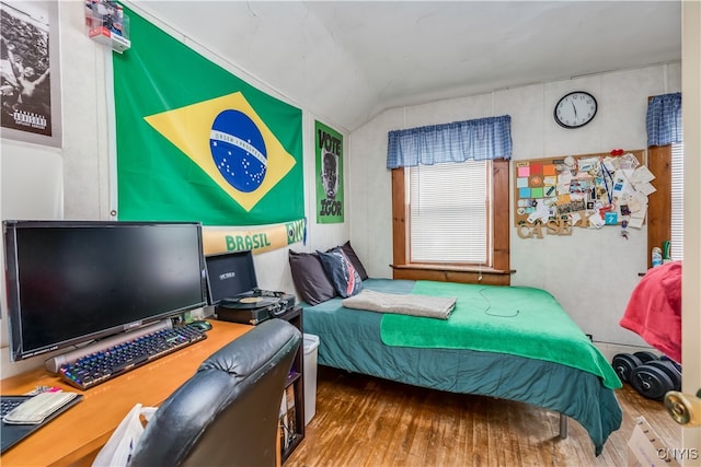 bedroom featuring lofted ceiling and hardwood / wood-style floors