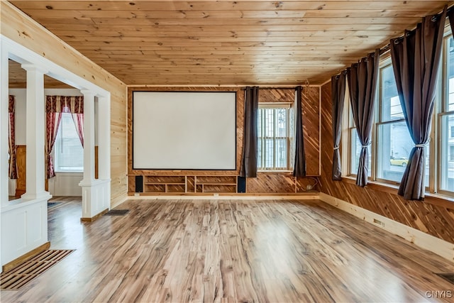 spare room with wood ceiling, light hardwood / wood-style flooring, wooden walls, and ornate columns