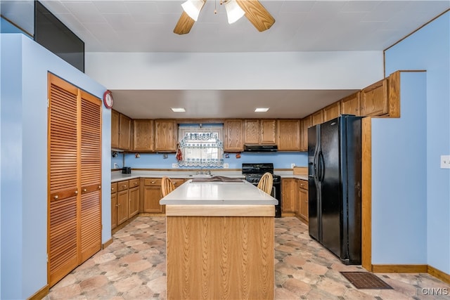 kitchen with black appliances, exhaust hood, a kitchen island, and ceiling fan