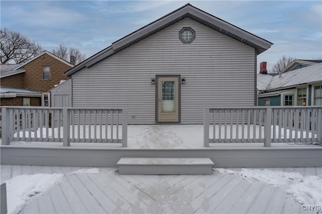 snow covered property featuring a deck