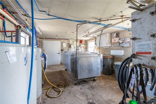 laundry area featuring water heater, washer / clothes dryer, and a garage