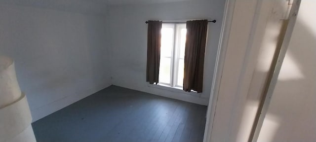 unfurnished room featuring dark hardwood / wood-style flooring