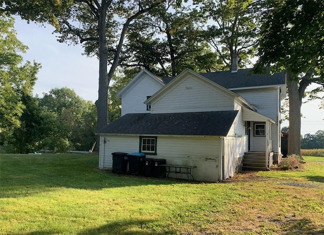 back of house featuring a yard