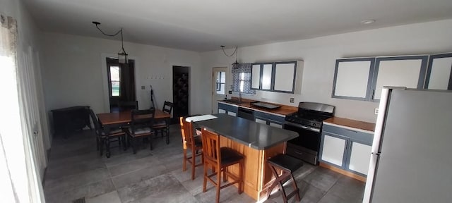 kitchen with a center island, black appliances, and a kitchen bar