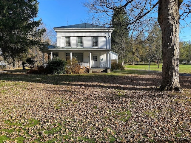 view of front of house with a porch and a front yard