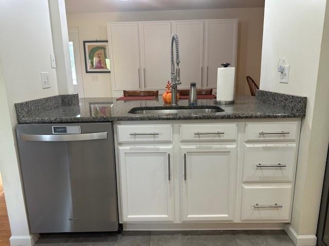 kitchen with dishwasher, white cabinets, and dark stone counters