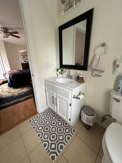 bathroom featuring tile patterned floors, ceiling fan, toilet, and vanity