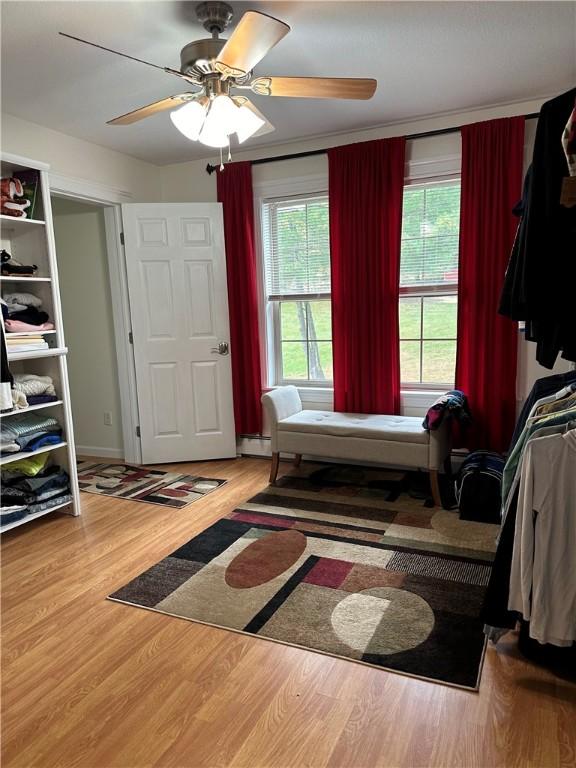 interior space with hardwood / wood-style floors and ceiling fan