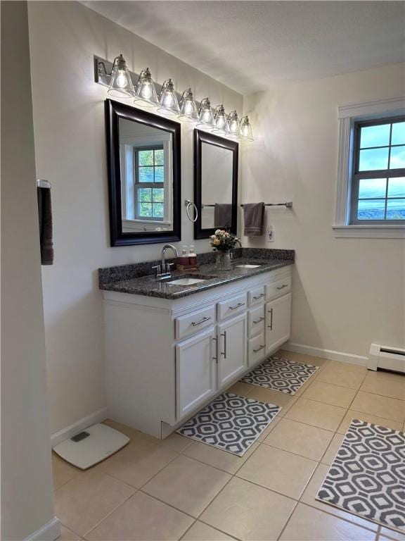 bathroom featuring tile patterned flooring, vanity, and baseboard heating