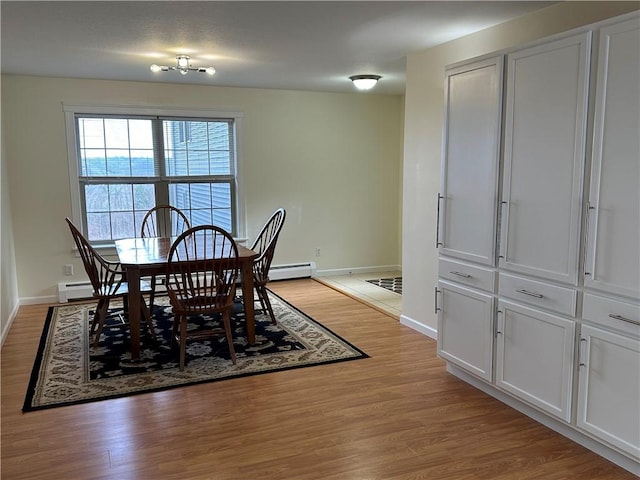 dining room featuring light hardwood / wood-style floors and a baseboard radiator