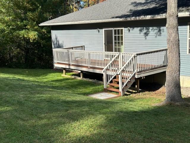 back of house with a yard and a deck