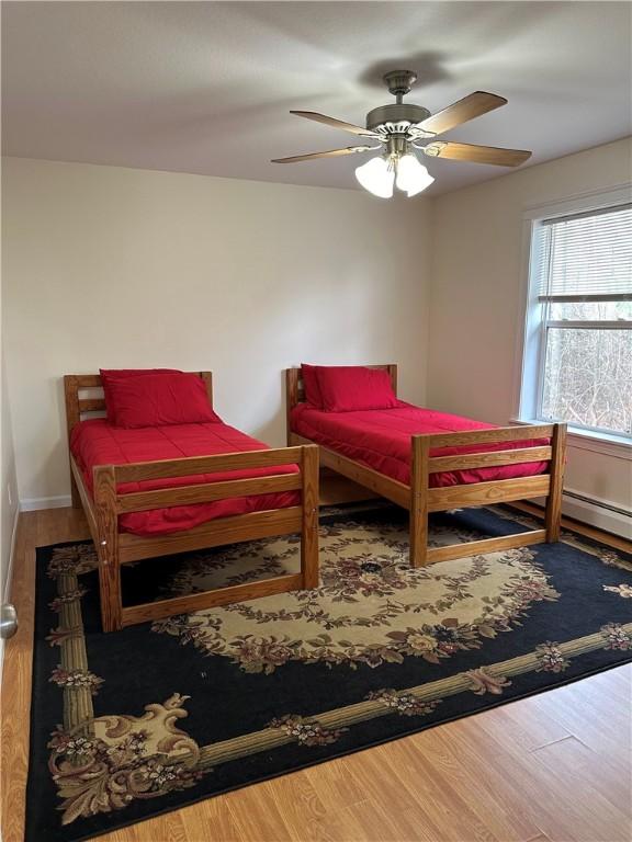 bedroom featuring wood-type flooring and ceiling fan