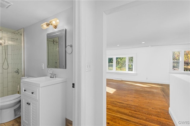 9869 Hazard Rd, Marcy, NY 13403 - bathroom with wood finished floors, plenty of natural light, toilet, and vanity