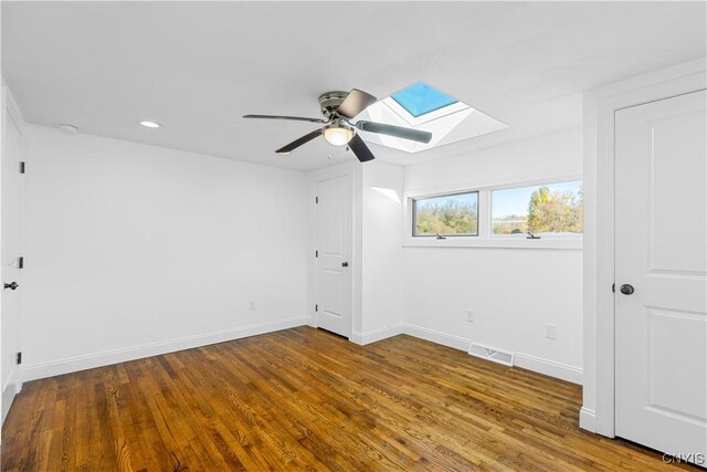9869 Hazard Rd, Marcy, NY 13403 - unfurnished bedroom featuring a skylight, wood finished floors, recessed lighting, baseboards, and a ceiling fan