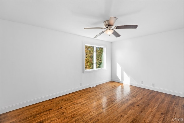 spare room with ceiling fan and wood-type flooring