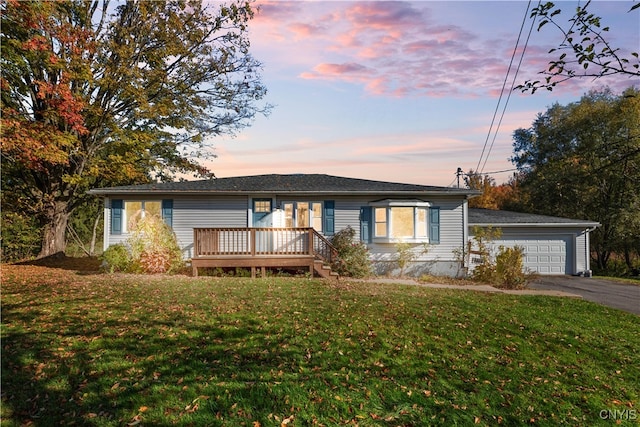 single story home featuring a yard and a garage