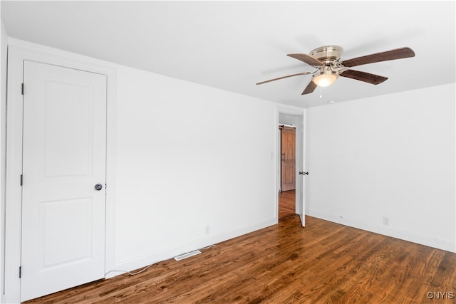 spare room featuring wood-type flooring and ceiling fan